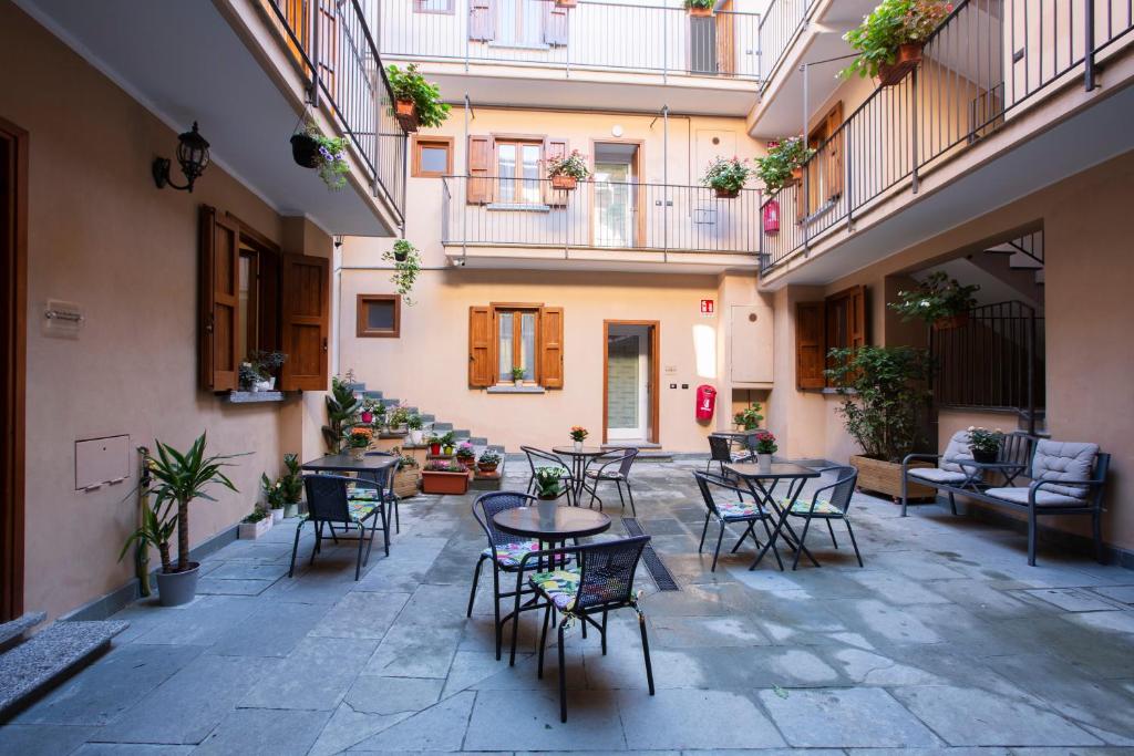 a courtyard with tables and chairs in a building at La Casa del Sarto - Rooms and Apartments in Lecco
