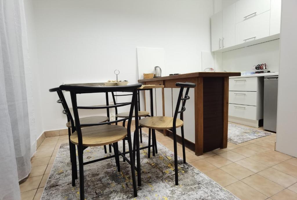 a kitchen with a black table and two chairs at Apartman Pearl in Sarajevo