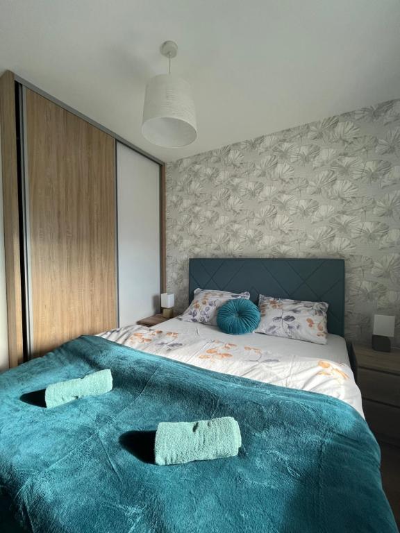 a bedroom with a bed with two towels on it at Apartman Vista Banja Luka in Banja Luka
