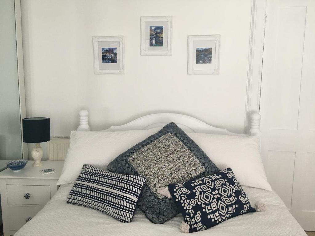 a white bed with two pillows on top of it at Parkview in Dunkeld