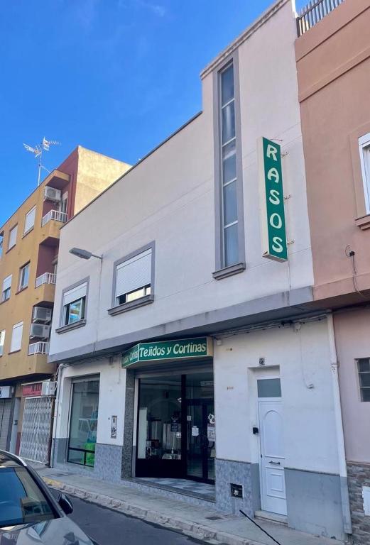 a building with a store on the side of a street at UIM Mediterraneo Pablo Iglesias Wifi in Puerto de Sagunto