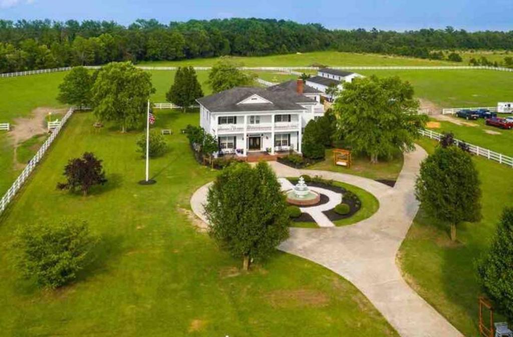 an aerial view of a large white house at The Barn Apartment at Parkton Place in Hope Mills