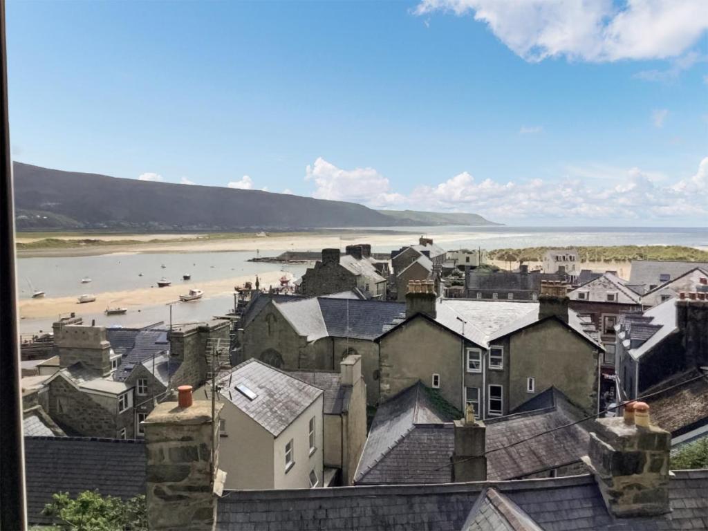 a view of a town with a beach and houses at Top Cottage in Barmouth