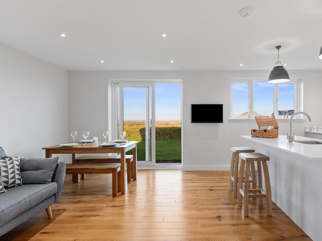 a kitchen and living room with a table and a couch at The Keys in Sardis