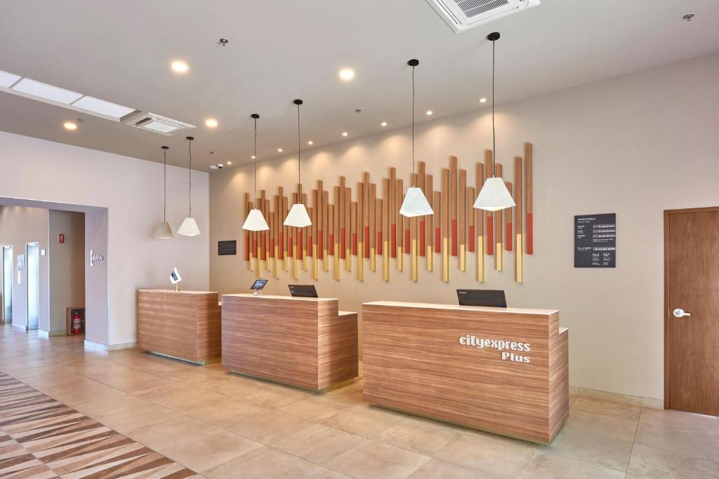 a lobby with a bunch of pipes on the wall at City Express Plus by Marriott Puerto Vallarta in Puerto Vallarta