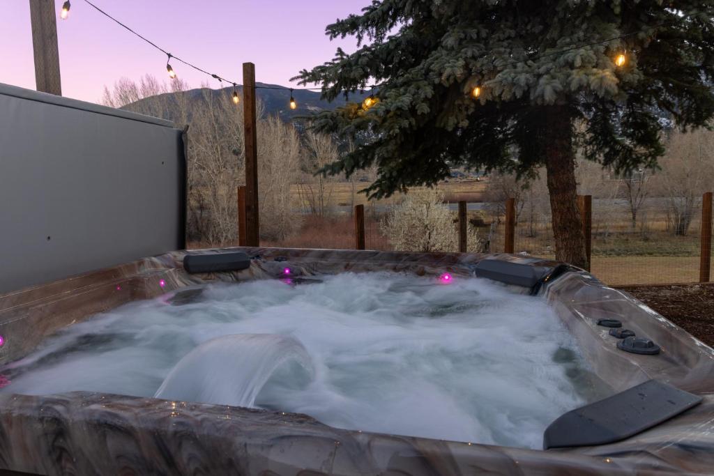 a hot tub filled with snow in a backyard at Great Salida Getaway - 20 minutes to Monarch with Spa & Gameroom in Salida