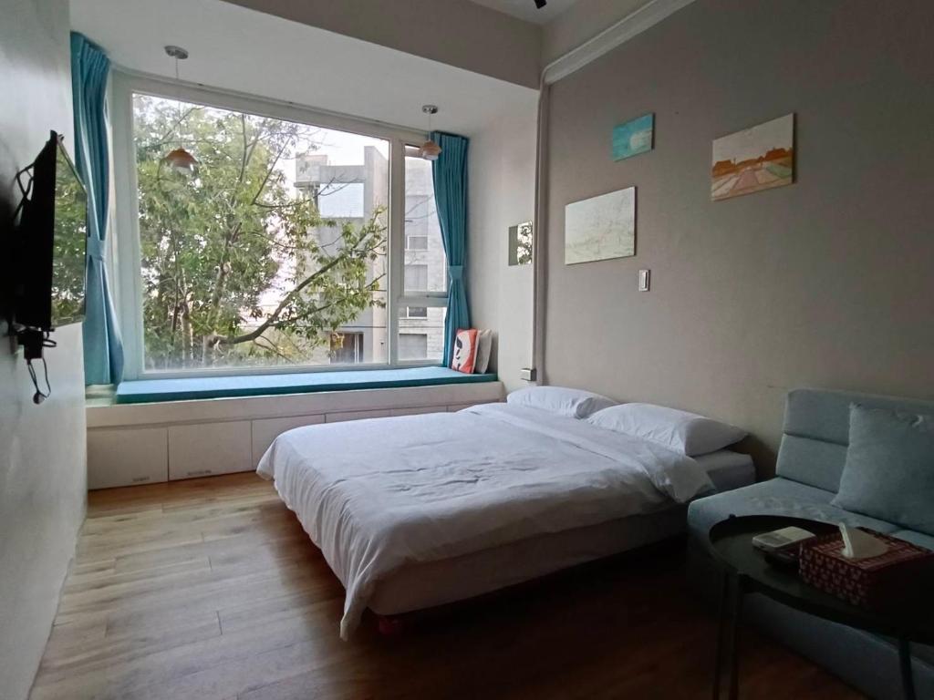 Postel nebo postele na pokoji v ubytování 東海小時光 Tong Hai Time Homestay