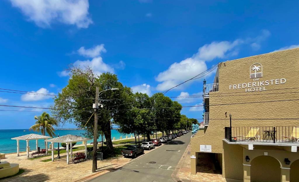 a building on a street next to the beach at The Frederiksted Hotel in Frederiksted