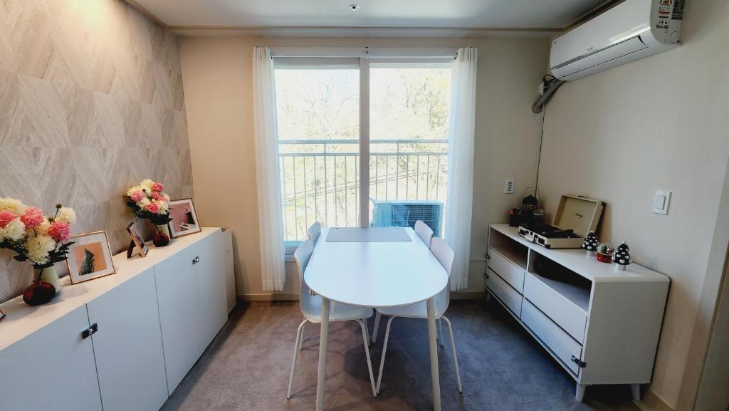 a kitchen with a white table and a window at Full option two-room, Exclusive use, mountain view, public transportation 5 minutes away in Seoul