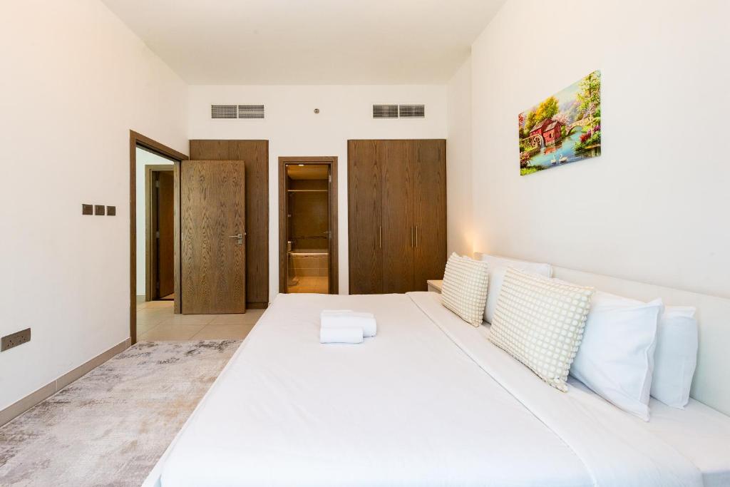 Postel nebo postele na pokoji v ubytování Beautiful contemporary 1BR Apt - Al Barsha South