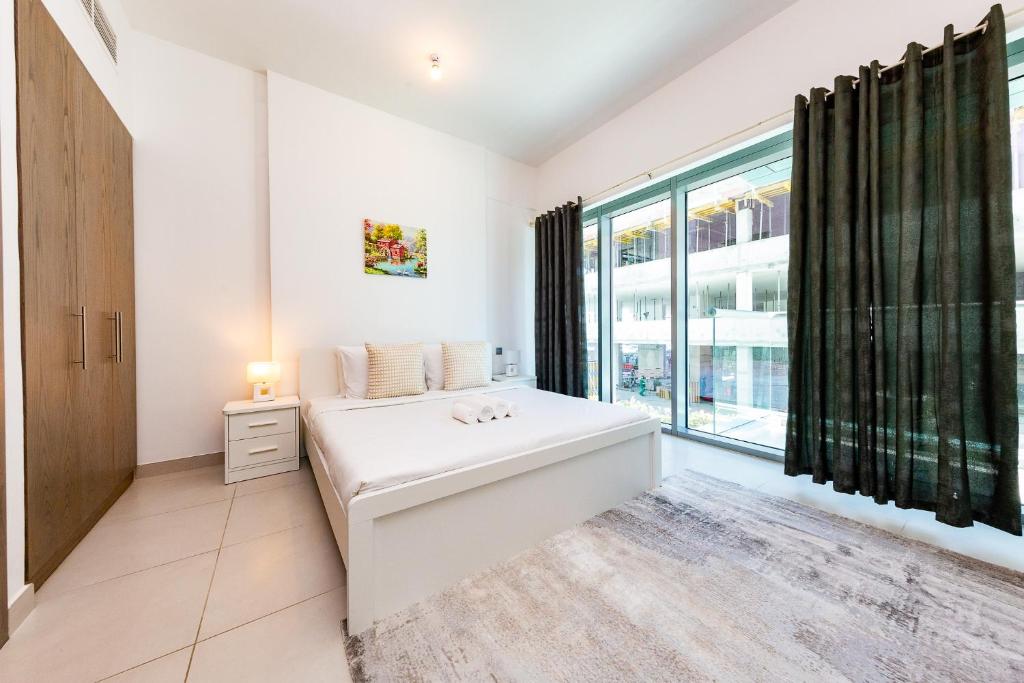 Postel nebo postele na pokoji v ubytování Beautiful contemporary 1BR Apt - Al Barsha South