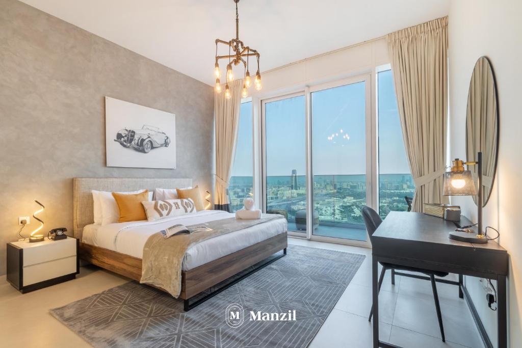 a bedroom with a bed and a desk and windows at Manzil - 2BR Apt in Al Wasl Residences with Park View, Dubai Trade Center in Dubai
