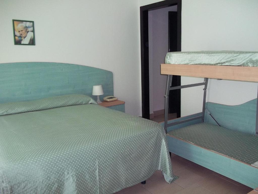 Postel nebo postele na pokoji v ubytování Hotel Rivabella