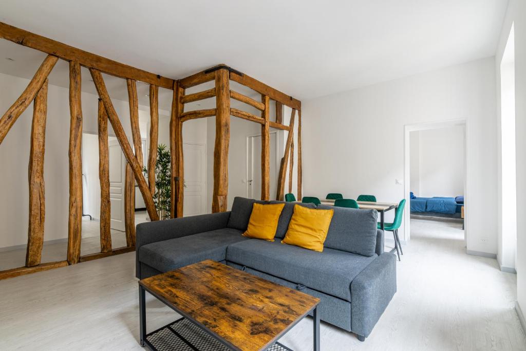a living room with a couch and a table at Luxurious 2 Bedroom Avenue des Champs-Élysées Saint-Philippe du Roule Free Netflix in Paris