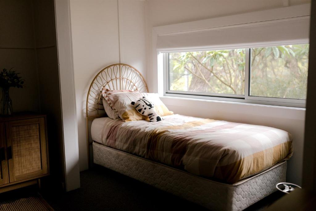 a bed in a room with a window at The Terrace @ Scarborough NSW 