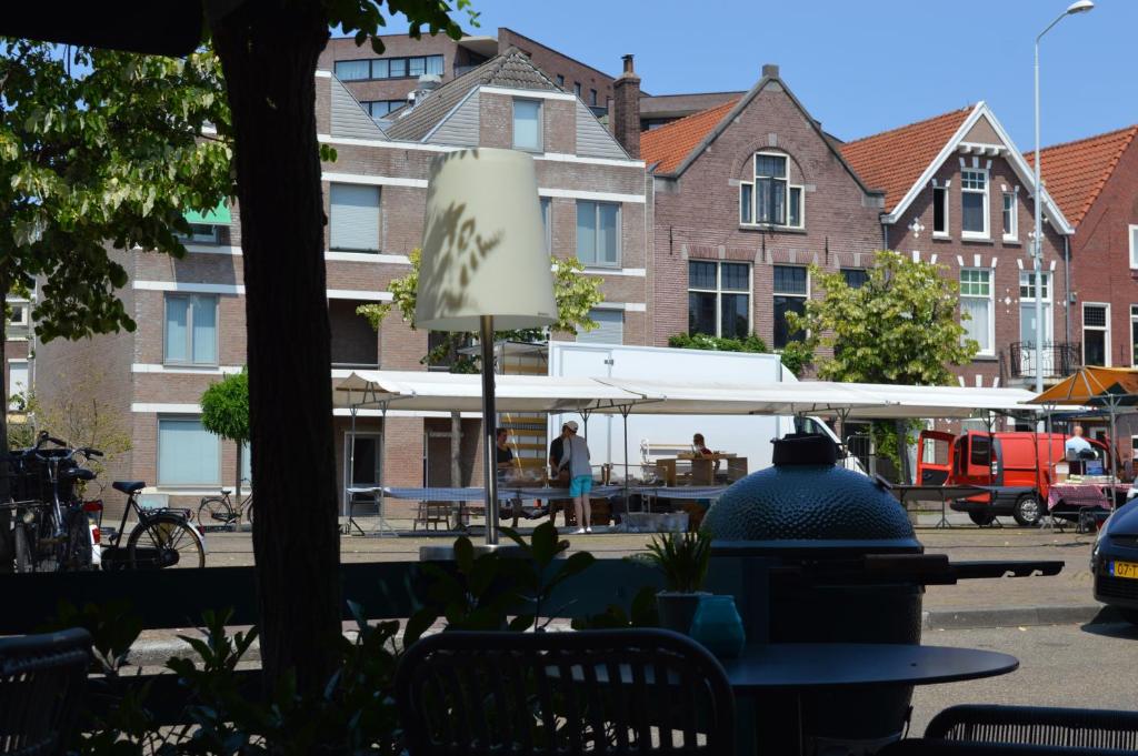 a restaurant with tables and umbrellas on a sunny day at Hotel Nassau in Eindhoven
