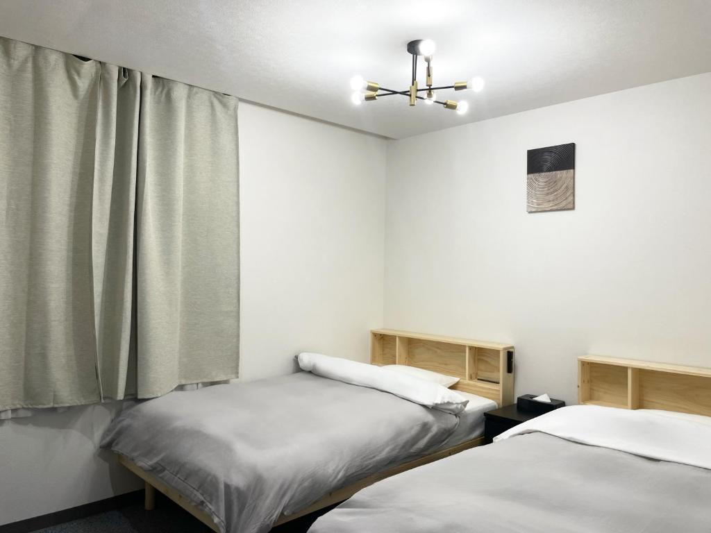 Postel nebo postele na pokoji v ubytování Hotel Royal Oak Gotanda