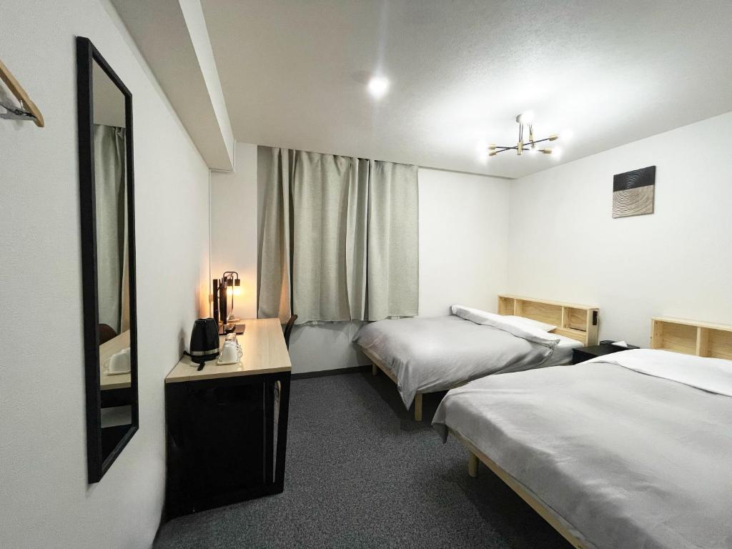 Postel nebo postele na pokoji v ubytování Hotel Royal Oak Gotanda