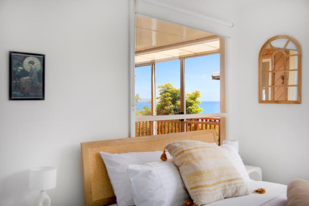 a bedroom with a bed with a view of the ocean at Stunning Ocean View Perfect For Groups & Families in Cooee