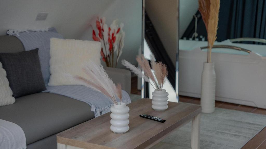 a living room with a couch and a table with feathers at Moon Light Camp in Bidiyah