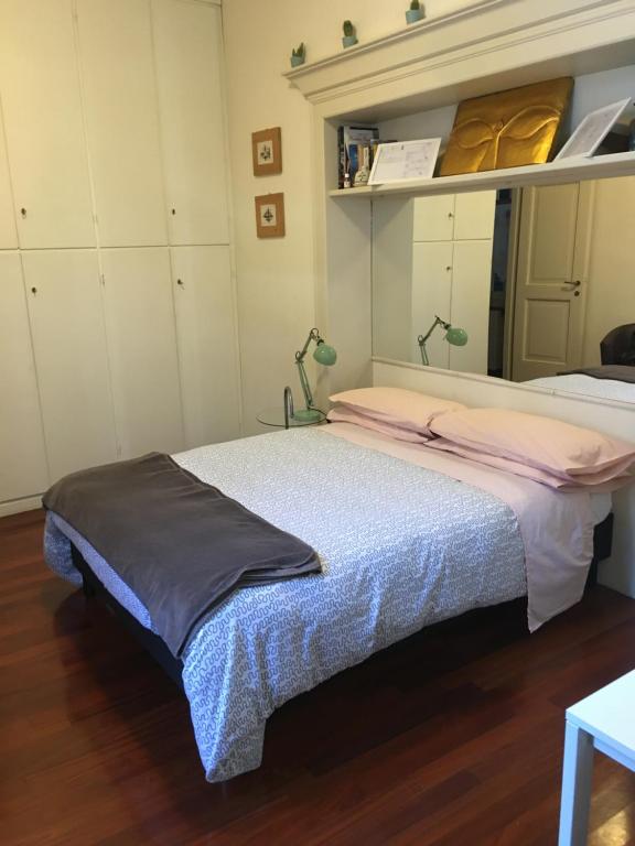 a bedroom with two beds and white cabinets at APPARTAMENTO GALLO in Brescia