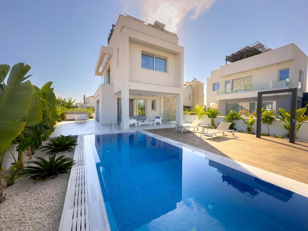 a villa with a swimming pool and a house at City Napa Seaview Villas - Villa 7 in Ayia Napa