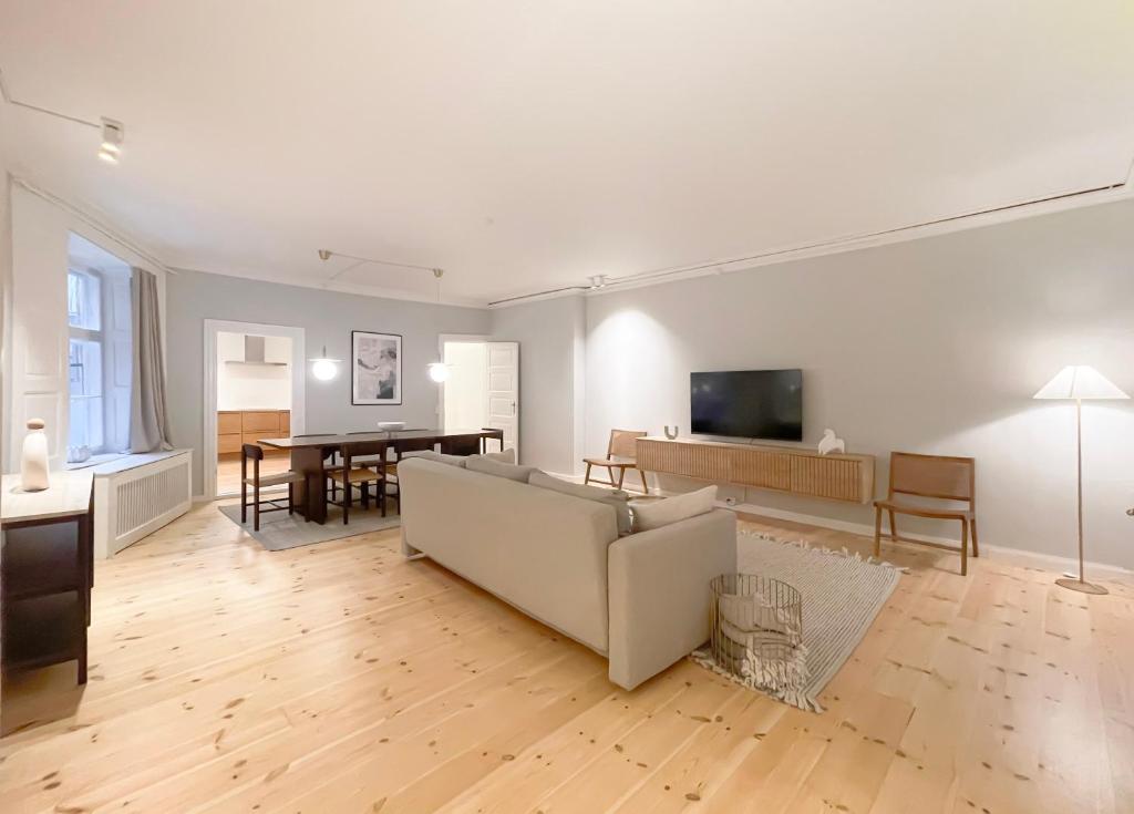 a living room with a couch and a table at Homely Apartment by CPH Canals in Copenhagen