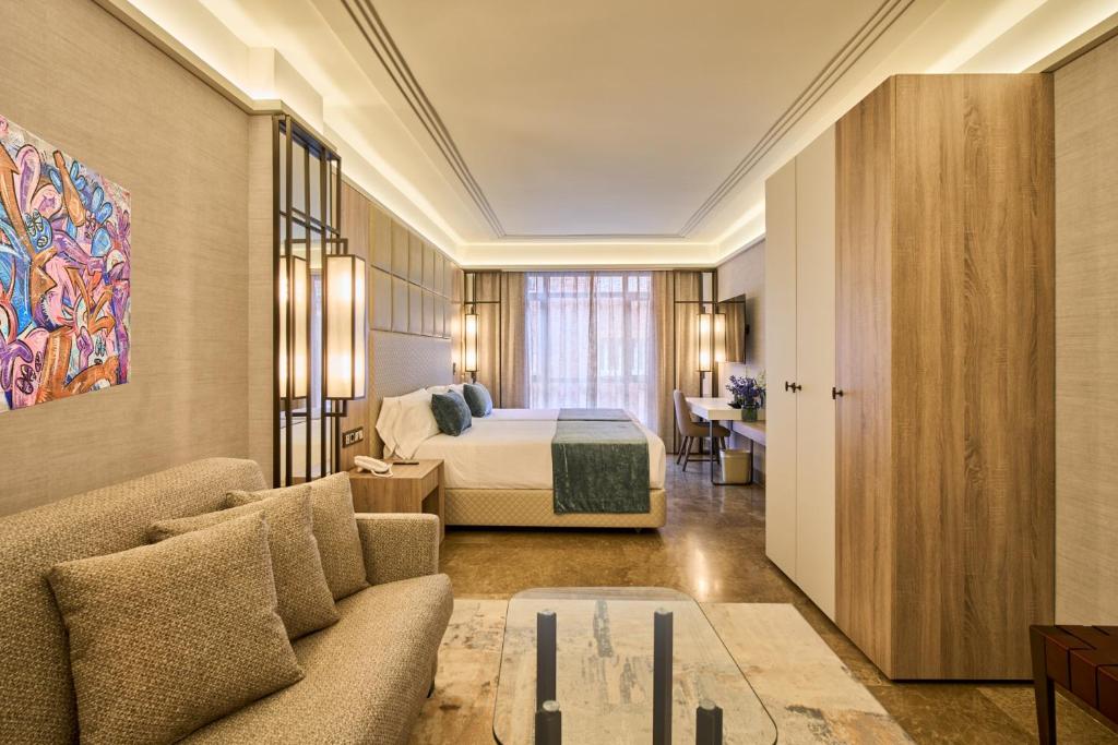 a hotel room with a bed and a couch at VP Madroño in Madrid