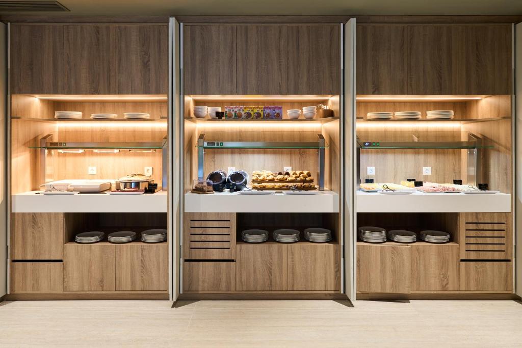 a closet with wooden cabinets with food in it at VP Madroño in Madrid