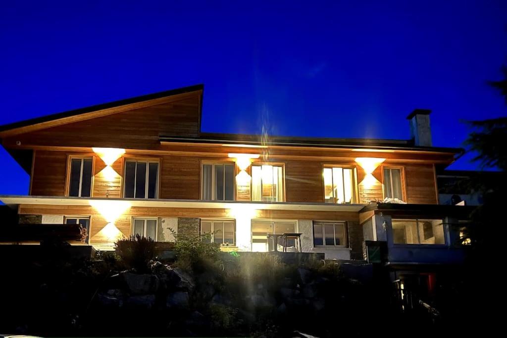 a house with lights on the side of it at night at Appartement Font-Romeu 2/4 pers. in Font-Romeu-Odeillo-Via