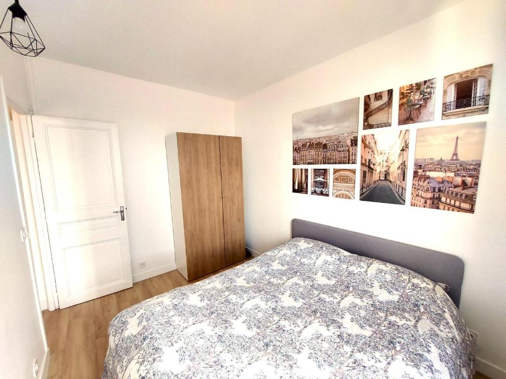 a bedroom with a bed and pictures on the wall at Superbe 2 pièces rénové et calme in Aubervilliers