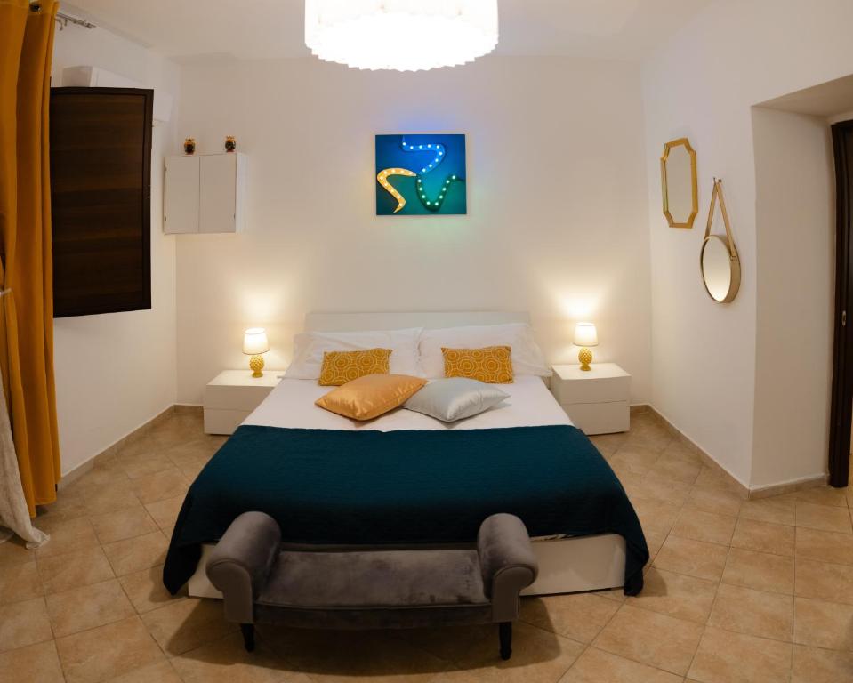 a bedroom with a large bed with two lamps at Briogna by Maravigghia Palermo in Palermo