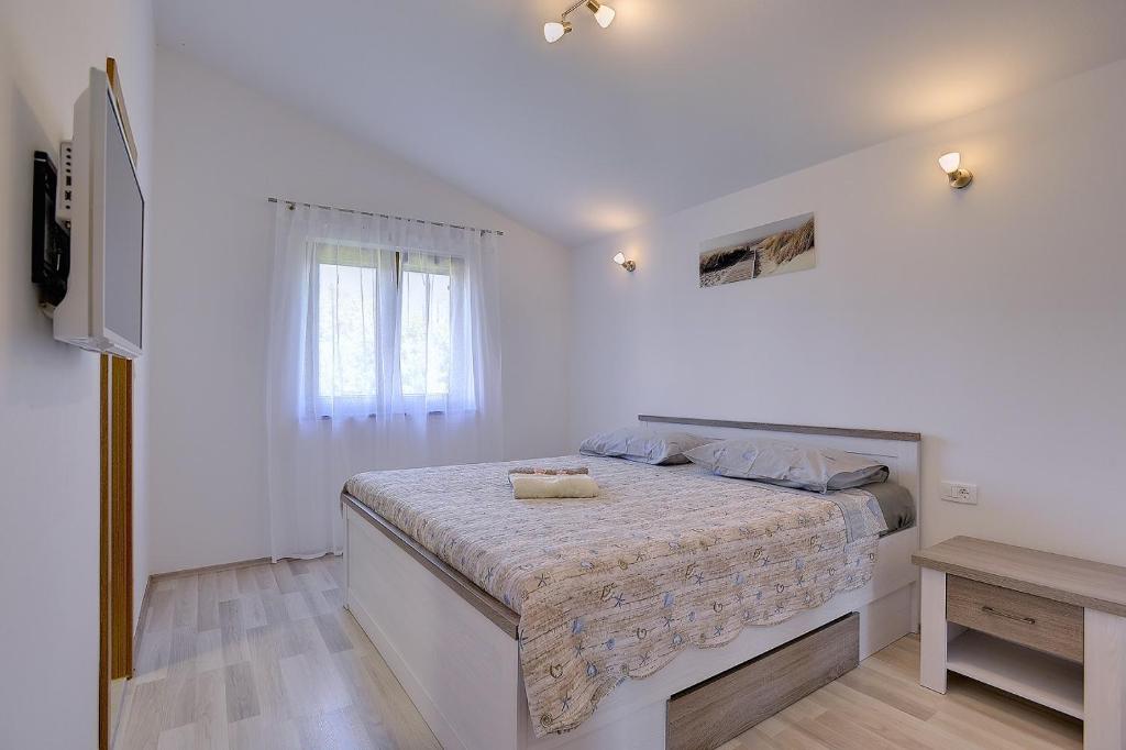 biała sypialnia z łóżkiem i oknem w obiekcie Casa Smoky w mieście Lindar