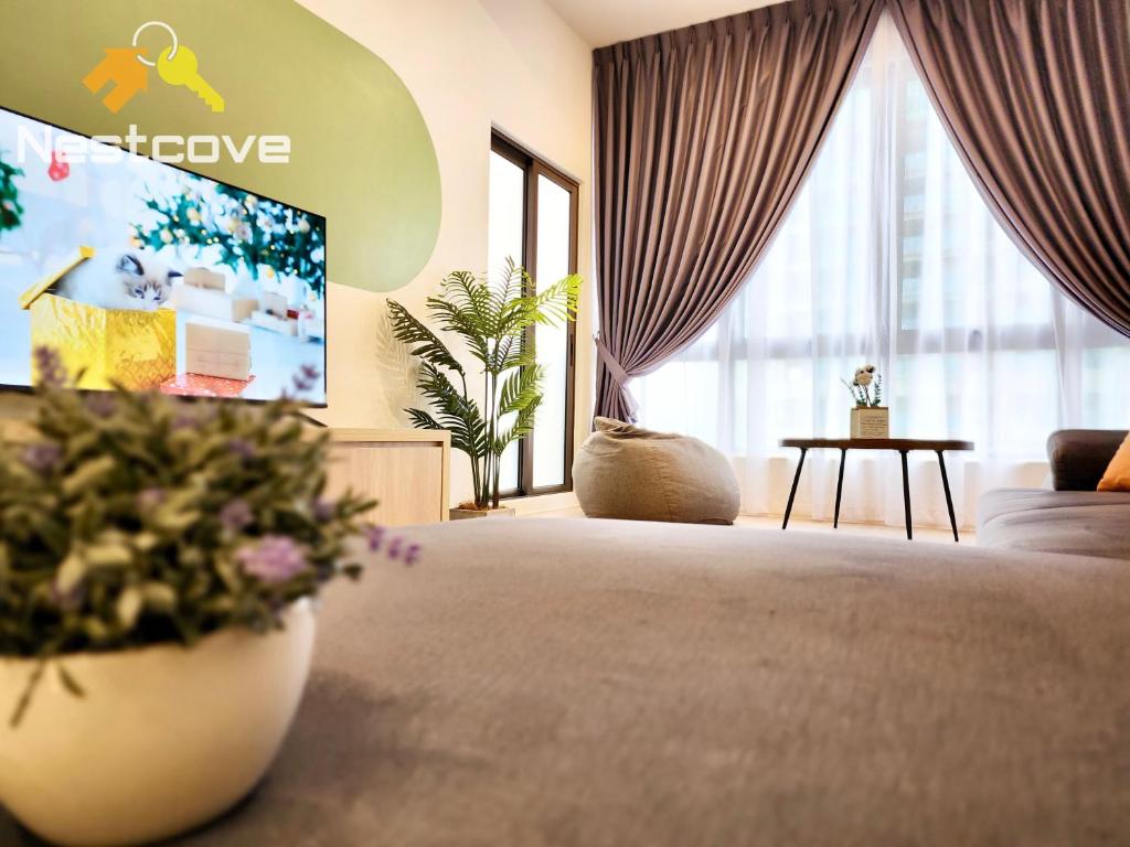 a hotel room with a large bed with a tv at Mutiara Bali Residence Suites By Nestcove in Melaka