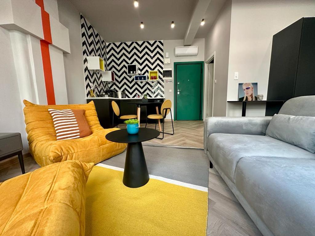 a living room with a couch and a table at Ermou funky lofts in Athens
