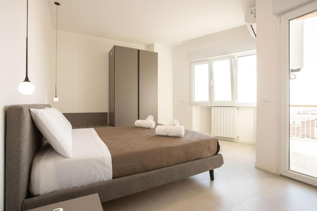 a bedroom with a bed with two stuffed animals on it at Luxury Cefalù Santa Maria in Cefalù