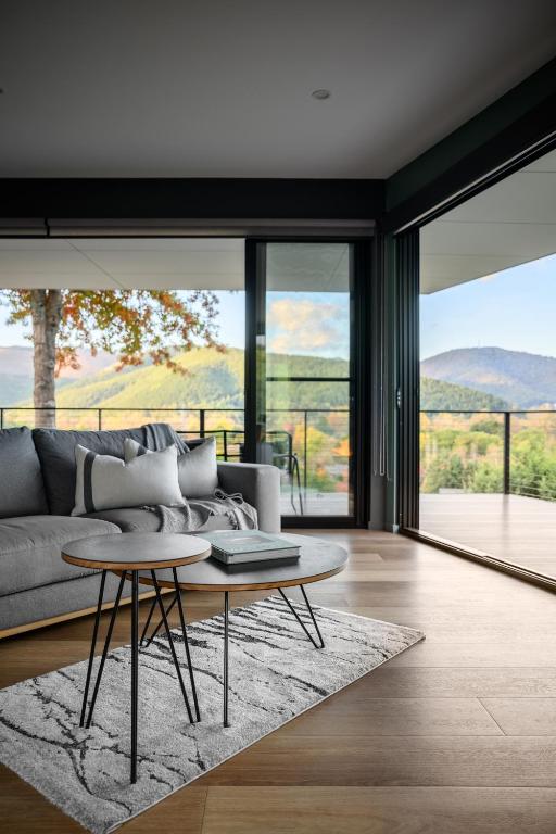 a living room with a couch and a table at The View Bright - Apartment 2 in Bright