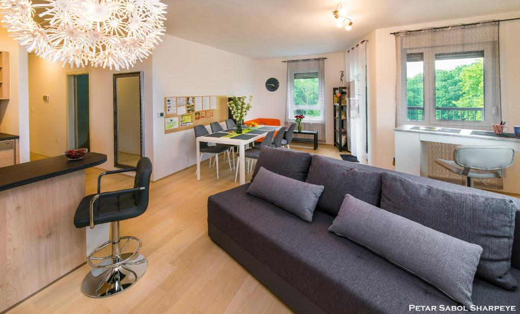 a living room with a couch and a dining room at City break apartment in Čakovec