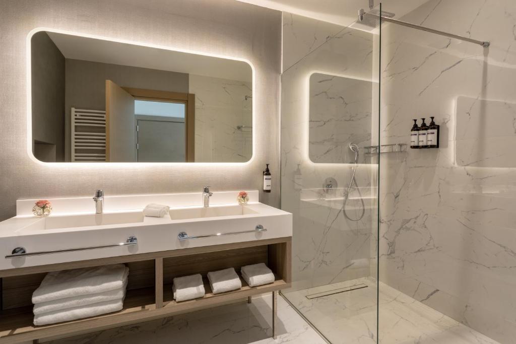 a bathroom with a sink and a shower at Hyatt Regency Kotor Bay Resort in Kotor
