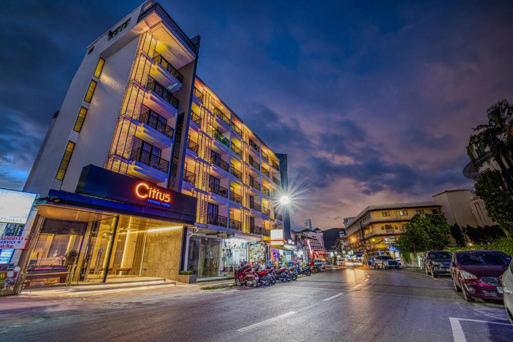 a building on a city street at night at Citrus Patong Hotel by Compass Hospitality in Patong Beach
