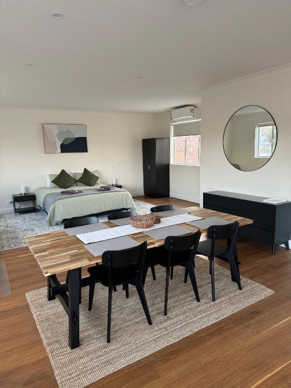 a bedroom with a bed and a table and chairs at Away on Blende Studio Loft in Broken Hill