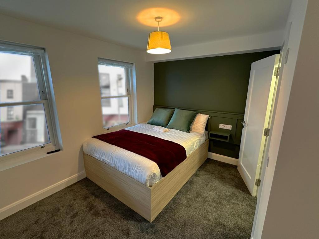a bedroom with a bed in a room with a window at Mary Mullen's Rooms Eyre Square. in Galway