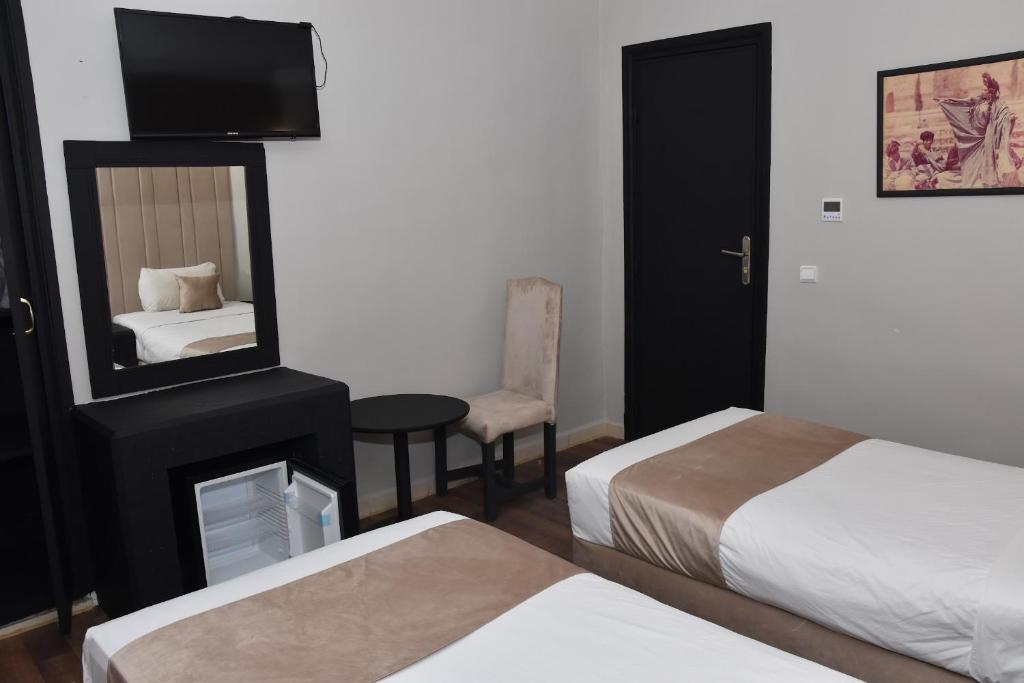 Postel nebo postele na pokoji v ubytování Cadé Hotel