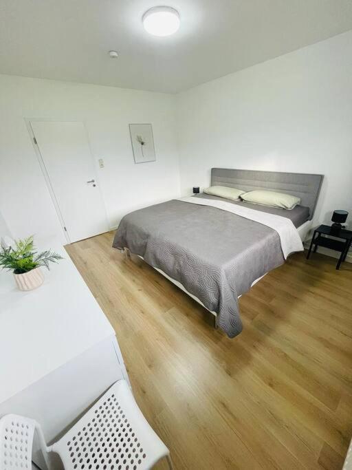a bedroom with a large bed and a wooden floor at Ferienwohnung in Herscheid in Herscheid