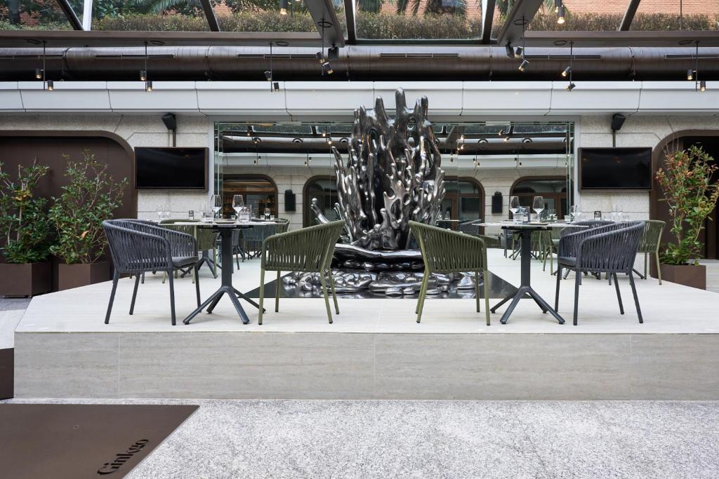 a table and chairs and a fountain in a building at VP Madroño in Madrid