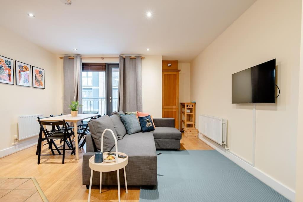 a living room with a couch and a table at Peaceful 2 bedrooms near St Patrick's Cathedral in Dublin