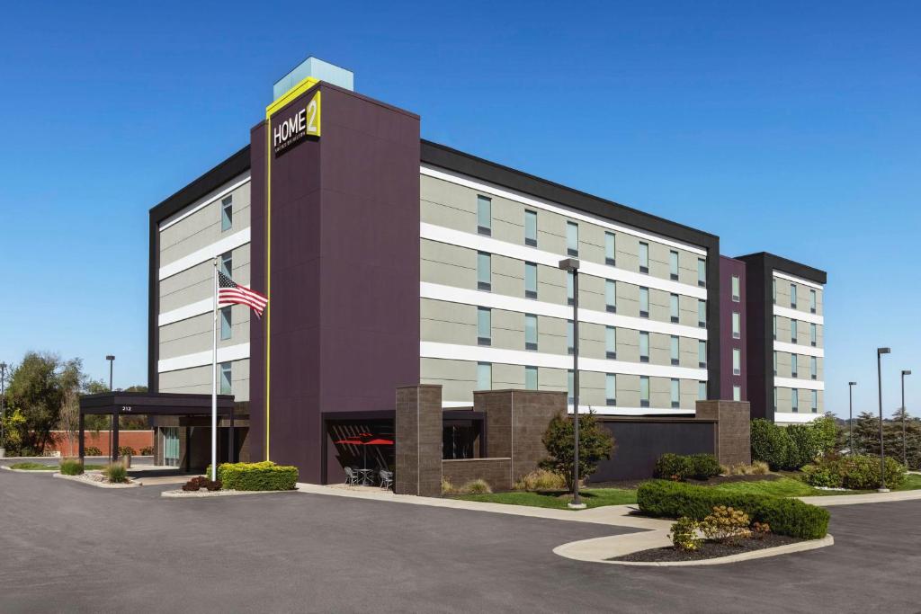 an office building with an american flag in front of it at Home2 Suites By Hilton York in York