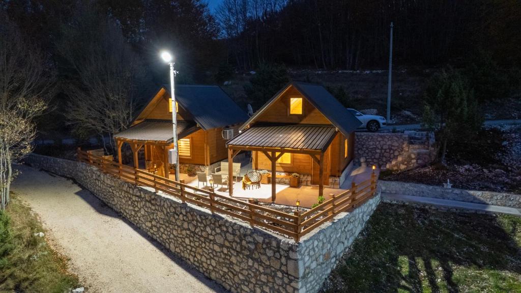 a large wooden house with a stone wall at Oasis of Peace in Cetinje