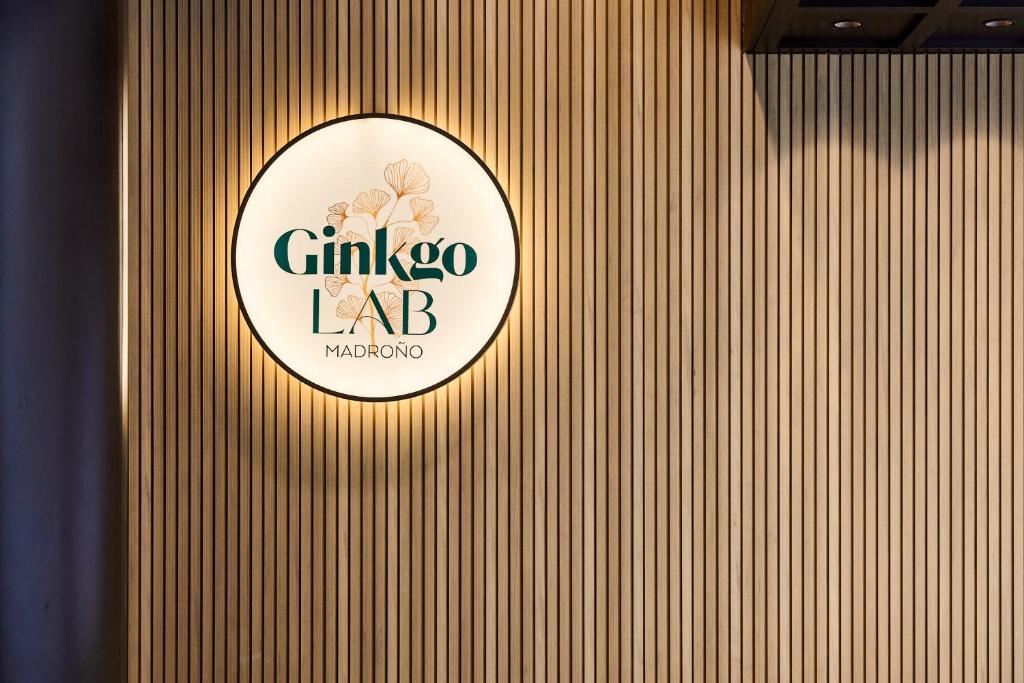 a sign on a wooden wall with a logo on it at VP Madroño in Madrid