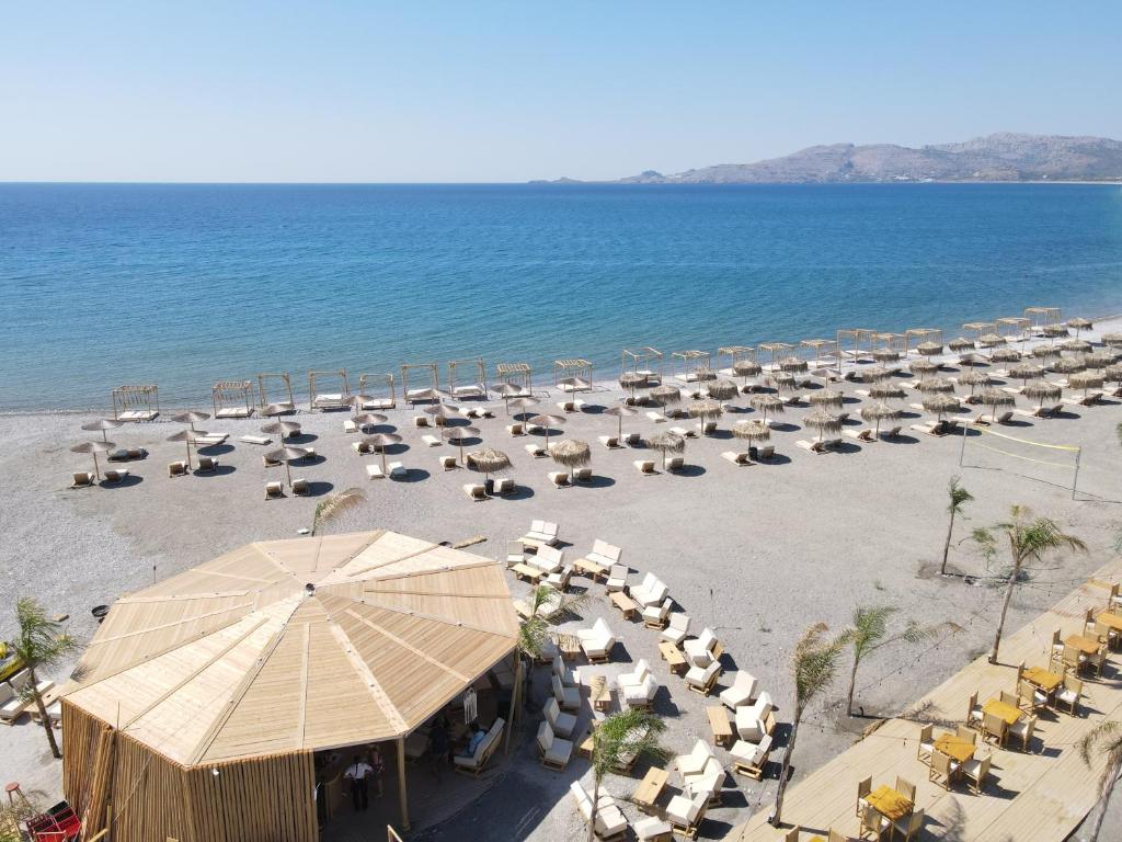 an overhead view of a beach with chairs and umbrellas at Alia Apartments and Suites in Haraki